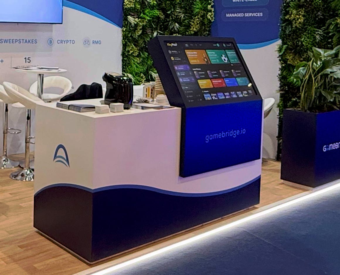 The demo console on the GameBridge stand showing a casino lobby on a touchscreen